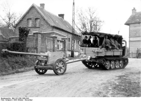 Click to view full size image
 ============== 
7.5 cm PaK 40 being towed by a tracked vehicle, Northern France, Oct 1943.

Source: German Federal Archive
