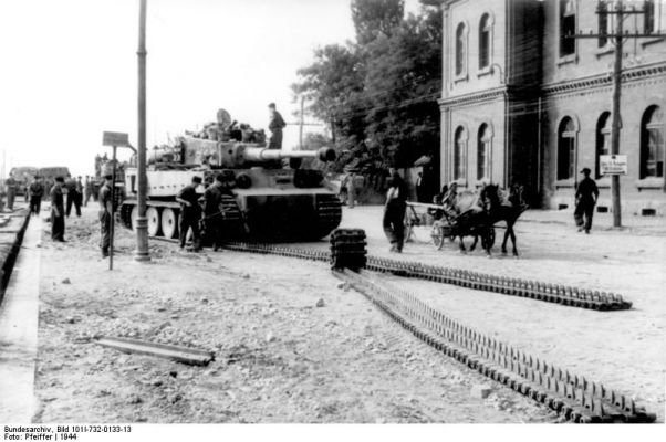Click to view full size image
 ============== 
Troops of the German \'Großdeutschland\' Division changing tracks of a Tiger I heavy tank in a Romanian town, 1944.

Source: German Federal Archive
