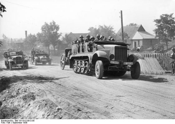 Click to view full size image
 ============== 
German SdKfz. 6 half-track vehicle towing a howitzer and carrying troops in Poland, Sep 1939.

Source: German Federal Archive
