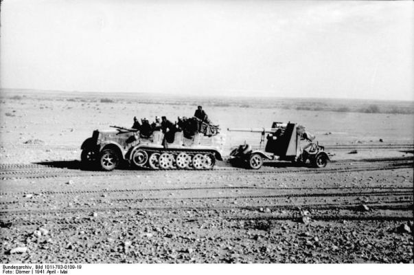 Click to view full size image
 ============== 
German Army SdKfz. 7 half-track vehicle towing a 8.8 cm FlaK gun in North Africa, Apr 1941.

Source: German Federal Archive

