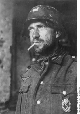Click to view full size image
 ============== 
A German soldier in Stalingrad, Russia, Nov 1942; note silver assault badge on his chest.

Source: German Federal Archives
