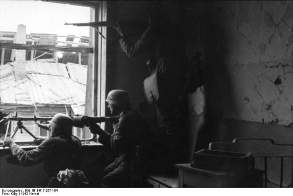 Click to view full size image
 ============== 
Soviet Union, Stalingrad. - Three German soldiers in a building with machine gun 34 (mg 34) and rifle from a window shooting; PK KBK Lw zbV.

Source: German Federal Archive
